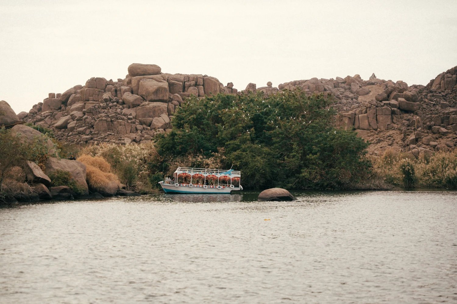 An Egyptian boat along the Nile’s green and granite shores